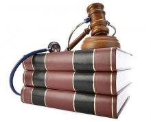 A stack of books with a gavel and stethoscope on top